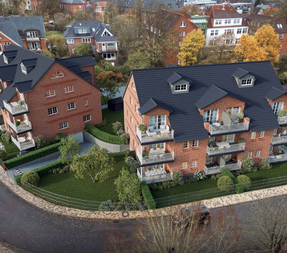 Foto aus der Vogelperspektive der zwei Häuser an der Kurve der Straße